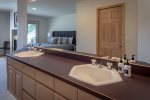The master suite features an oversized vanity as part of the ensuite.